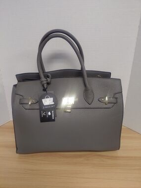 Grey leather handbag with concealed carry feature